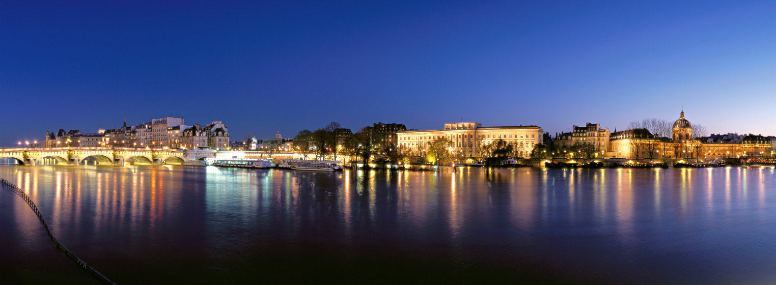 Panorama sur Paris : du pont Neuf à l'Institut de France au crépuscule 